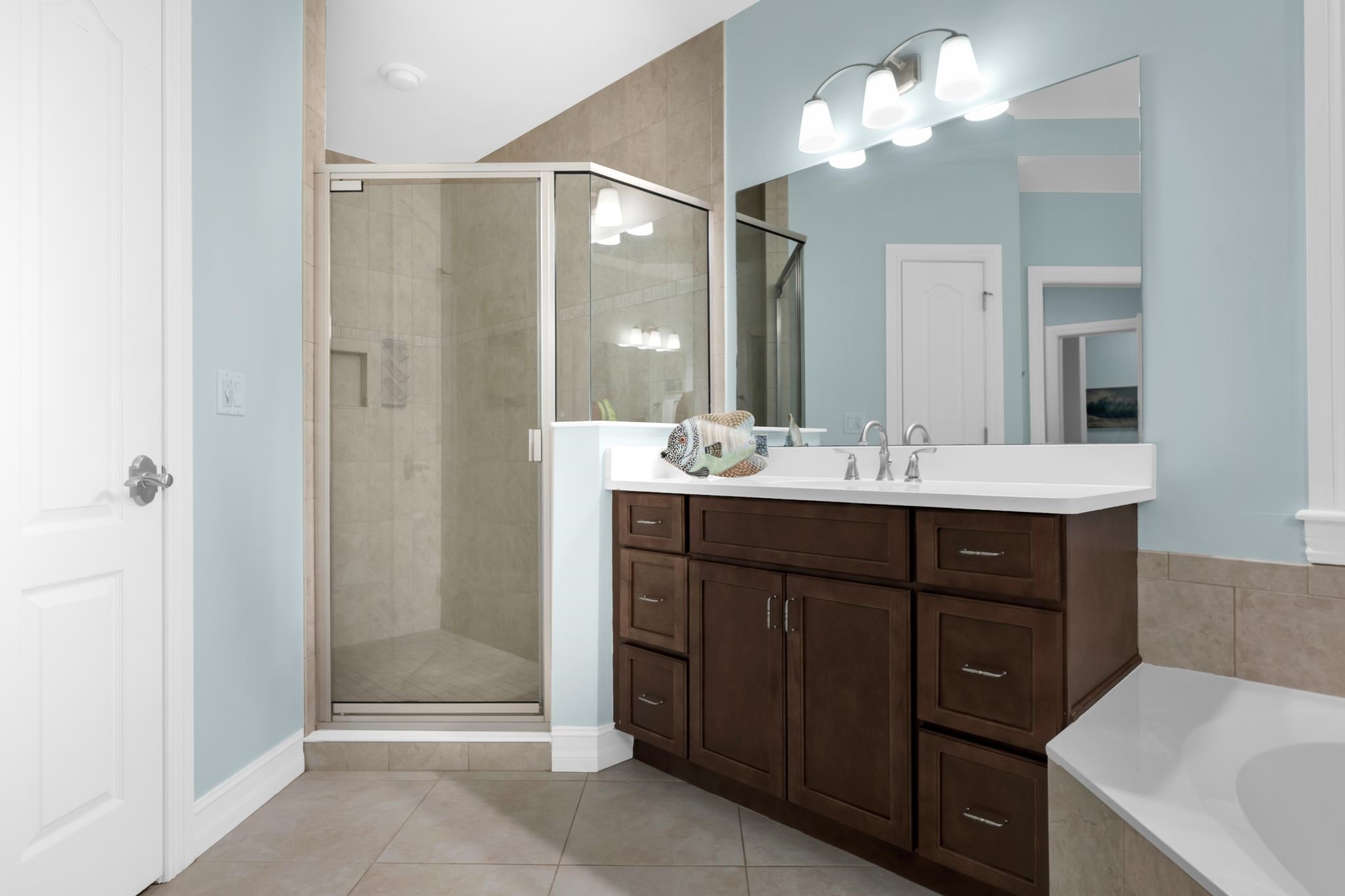 113 Needle Palm Drive St. Augustine, FL 32086 - Photo 28 of 46 a bathroom with a sink vanity and a mirror