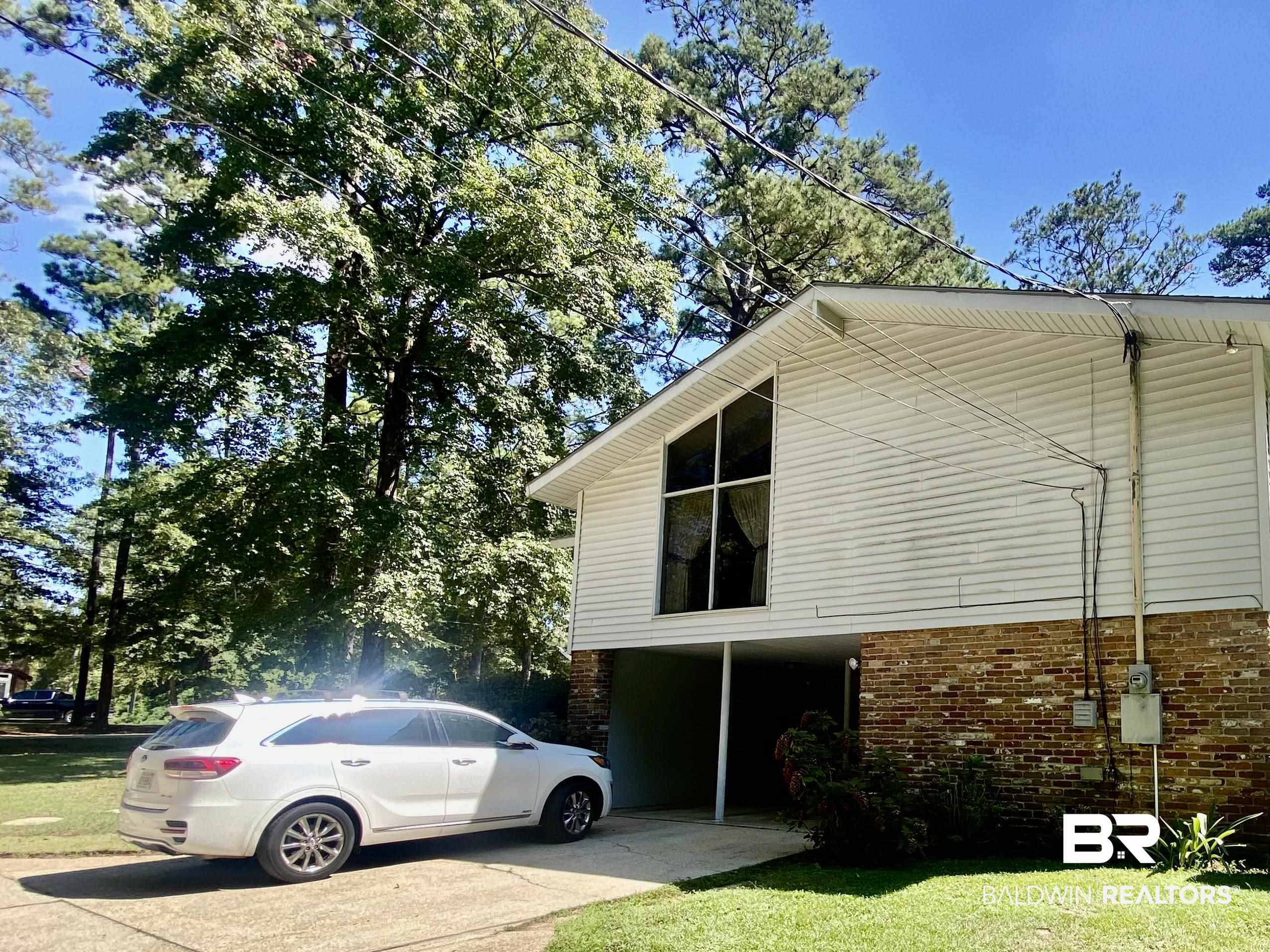 272 Longleaf Circle Monroeville, AL 36460 - Photo 33 of 38 View of side of property with a lawn.