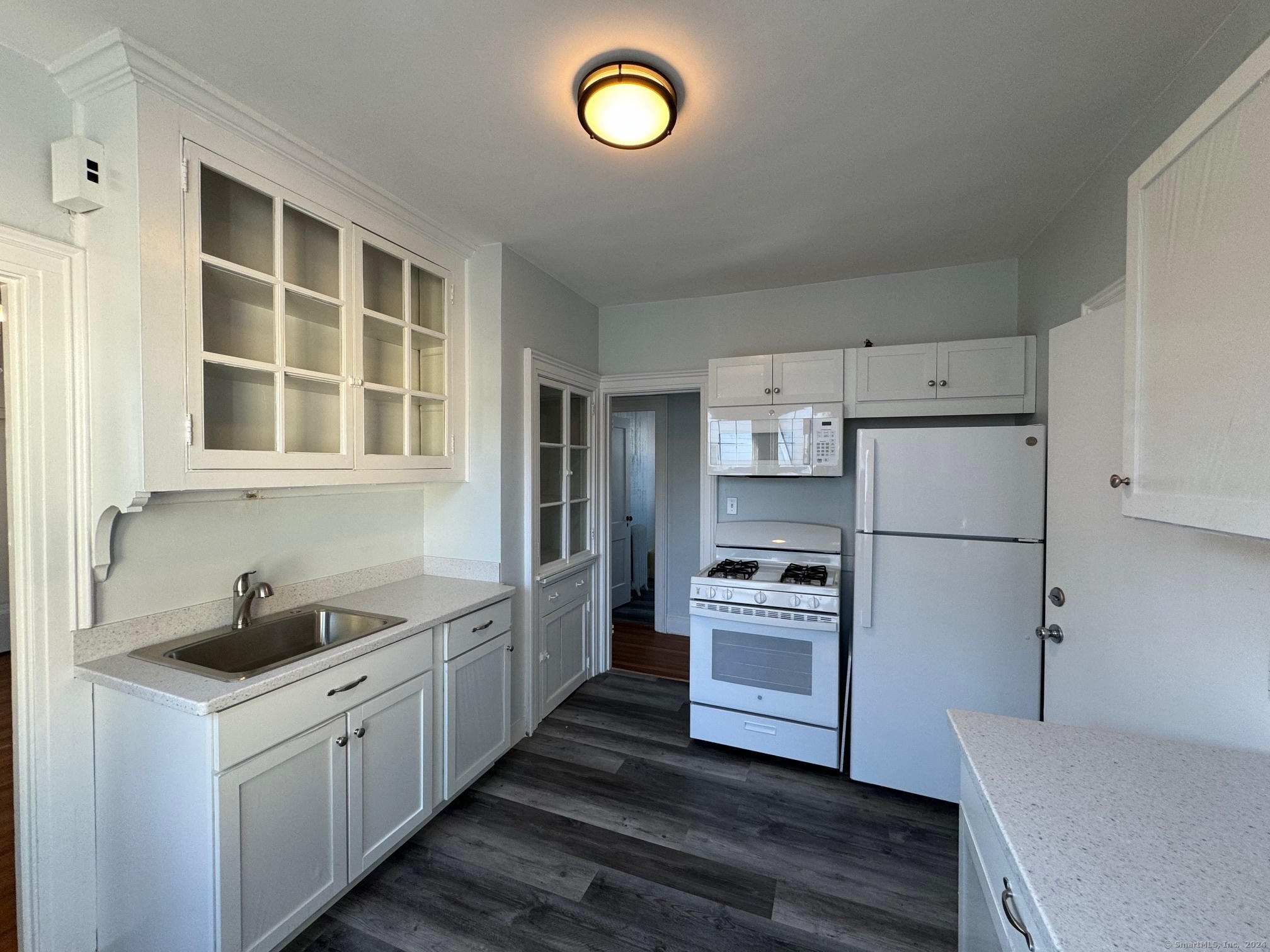 1253 Forest Road, Unit 2 New Haven, CT 06515 - Photo 22 of 30 a kitchen with cabinets and a stainless steel appliances