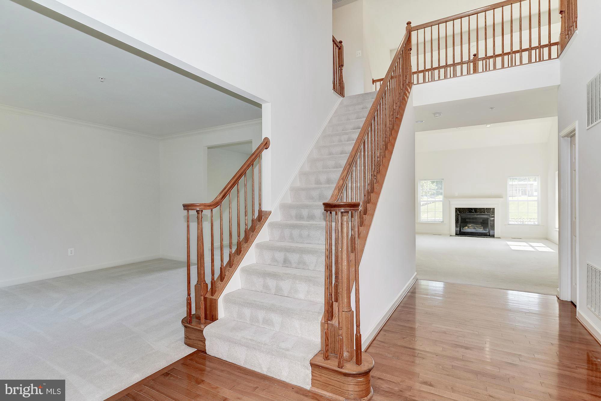 9700 Hickory Spring Lane Gaithersburg, MD 20882 - Photo 2 of 21 a view of staircase with wooden floor and a rug