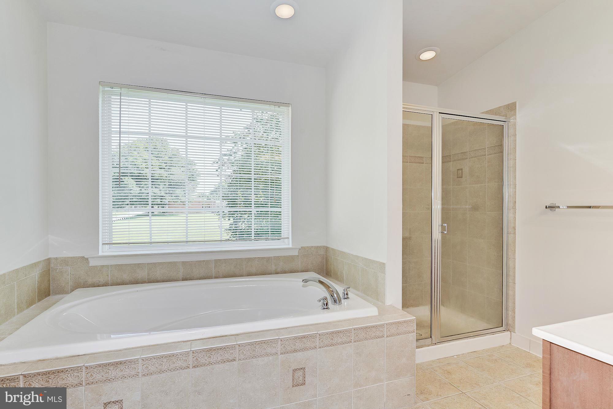 9700 Hickory Spring Lane Gaithersburg, MD 20882 - Photo 15 of 21 a bathroom with a bathtub and shower