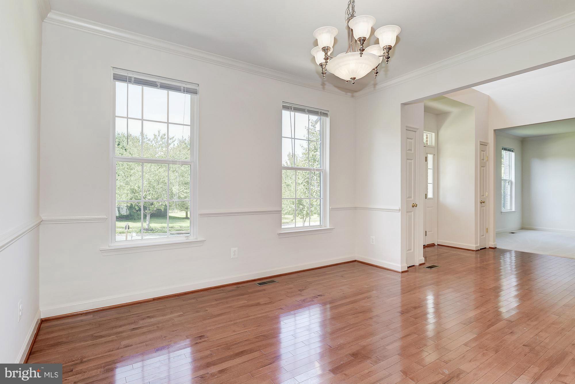 9700 Hickory Spring Lane Gaithersburg, MD 20882 - Photo 4 of 21 a view of an empty room with wooden floor and a window