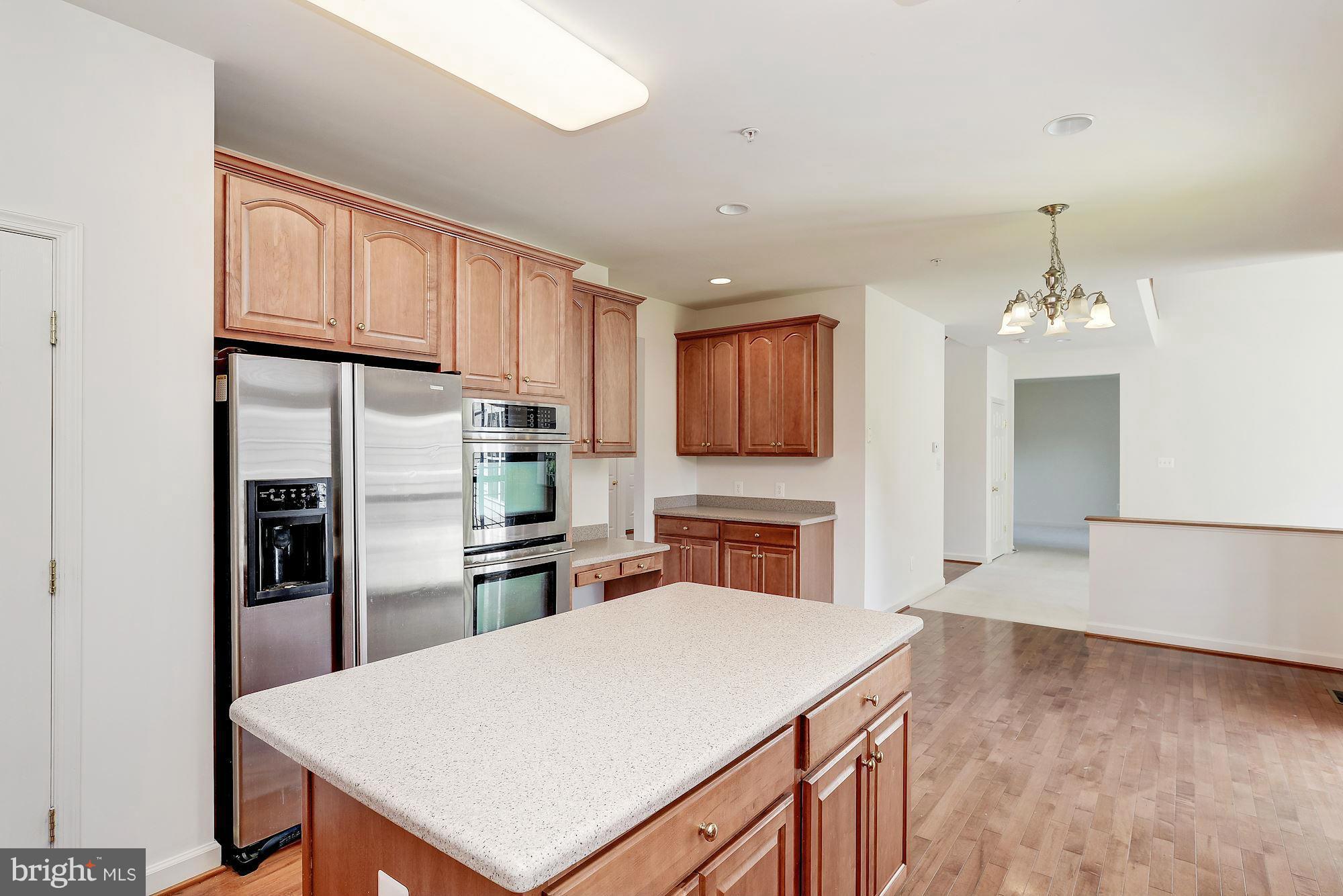 9700 Hickory Spring Lane Gaithersburg, MD 20882 - Photo 7 of 21 a kitchen with granite countertop a refrigerator stove top oven and sink