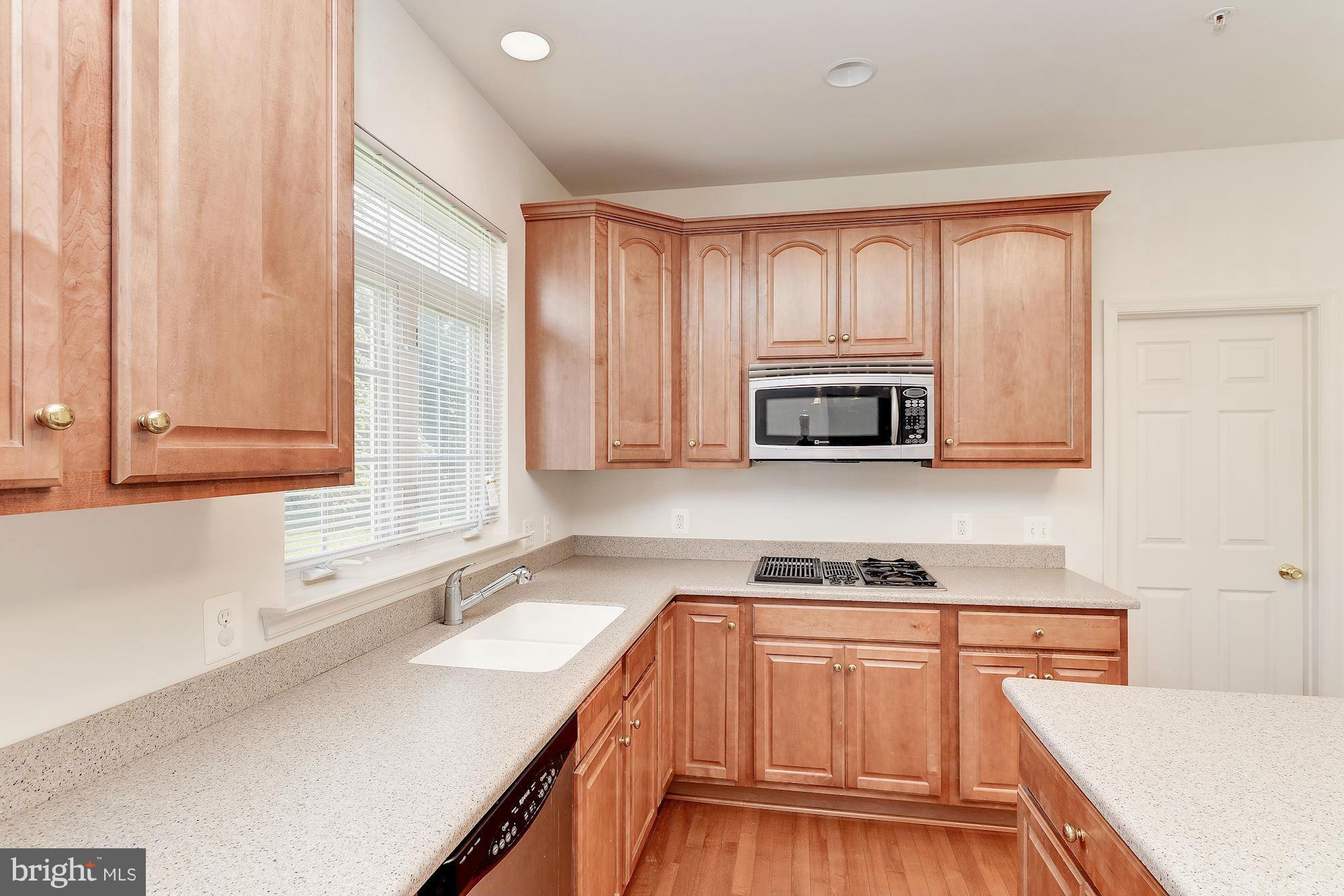 9700 Hickory Spring Lane Gaithersburg, MD 20882 - Photo 8 of 21 a kitchen with stainless steel appliances a stove sink and cabinets