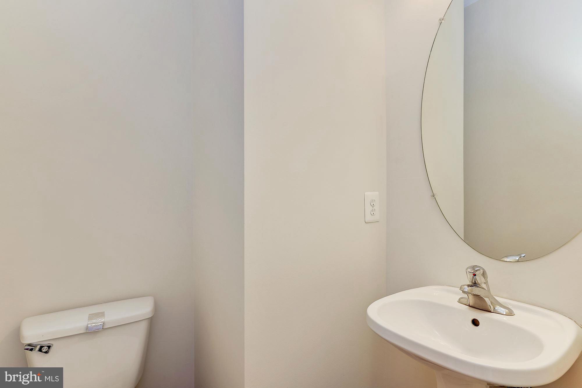 9700 Hickory Spring Lane Gaithersburg, MD 20882 - Photo 10 of 21 a bathroom with a sink a toilet and mirror