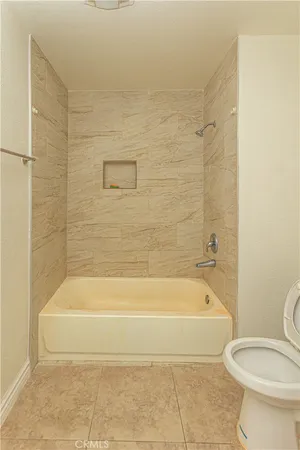 a bathroom with a toilet and bathtub