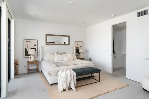 a spacious bedroom with a bed and walk in closet