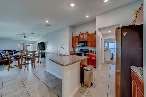 a kitchen with stainless steel appliances granite countertop a sink and a stove
