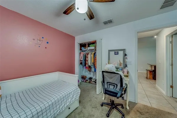 a bedroom with a bed and a chair