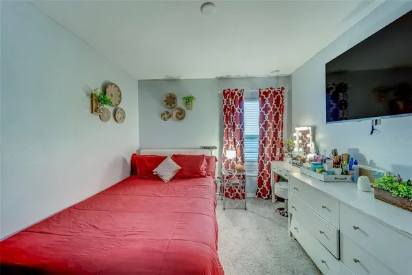 a bedroom with a bed and a flat screen tv