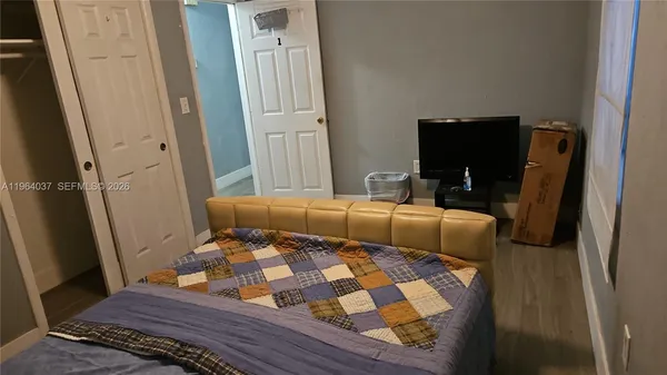 a bedroom with a bed and a mirror
