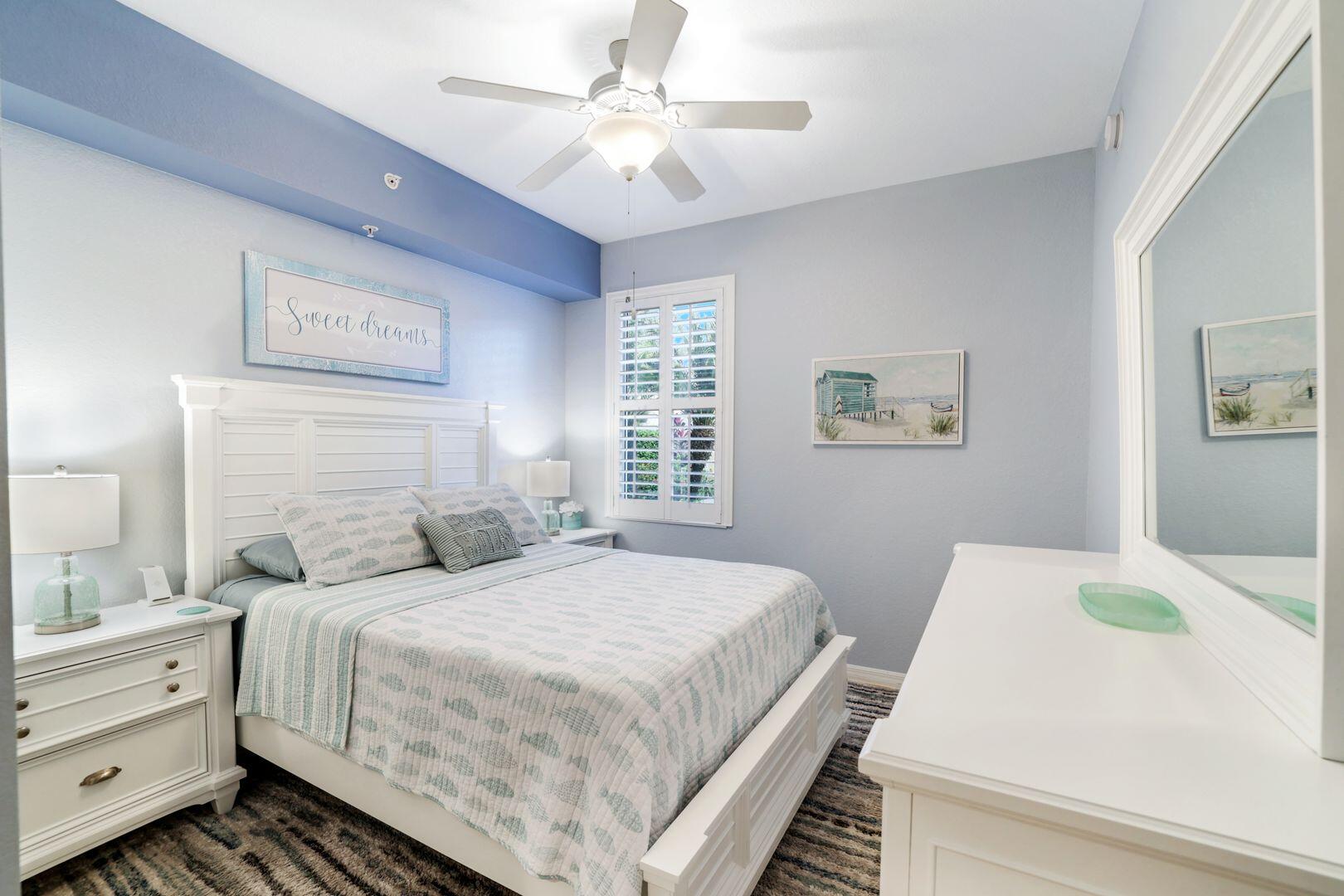 7878 Clemson Street, Unit 102 Naples, FL 34104 - Photo 11 of 20 a bedroom with a bed and a chandelier