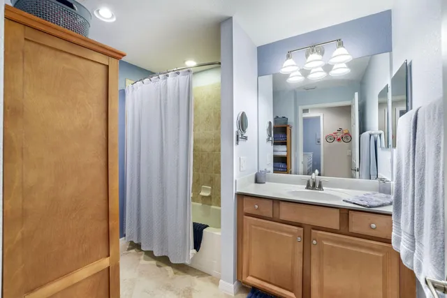 a bathroom with a shower sink and mirror