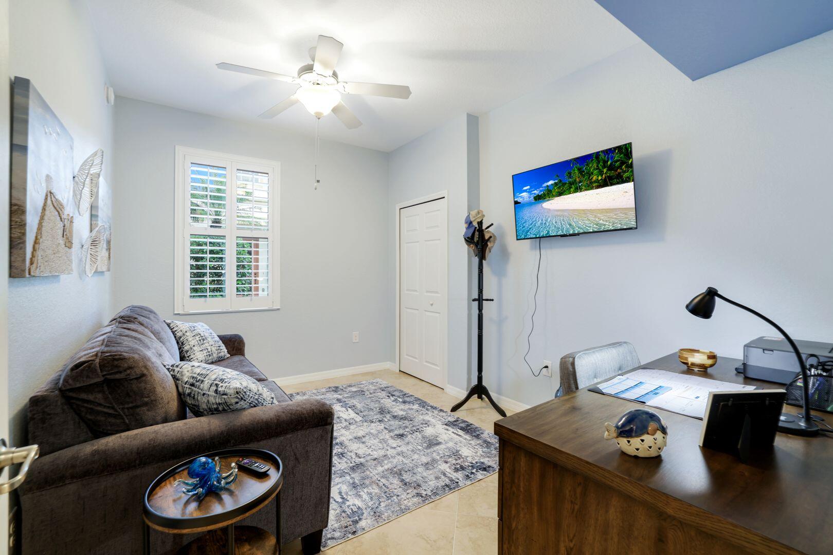 7878 Clemson Street, Unit 102 Naples, FL 34104 - Photo 13 of 20 a living room with furniture and a window