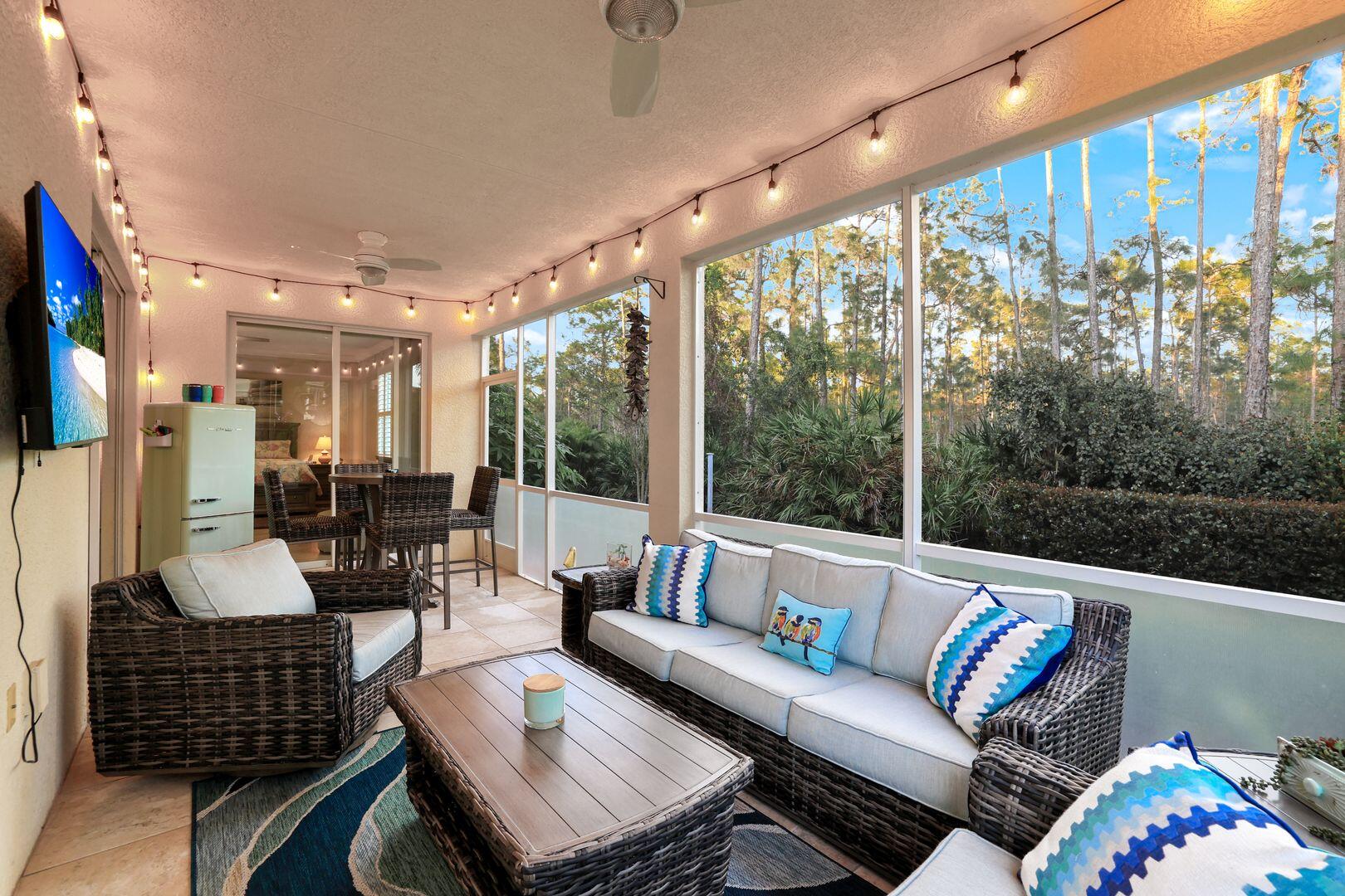7878 Clemson Street, Unit 102 Naples, FL 34104 - Photo 14 of 20 a living room with furniture and a large window