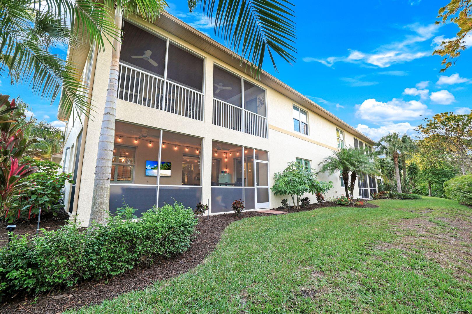 7878 Clemson Street, Unit 102 Naples, FL 34104 - Photo 17 of 20 a front view of a house with a yard