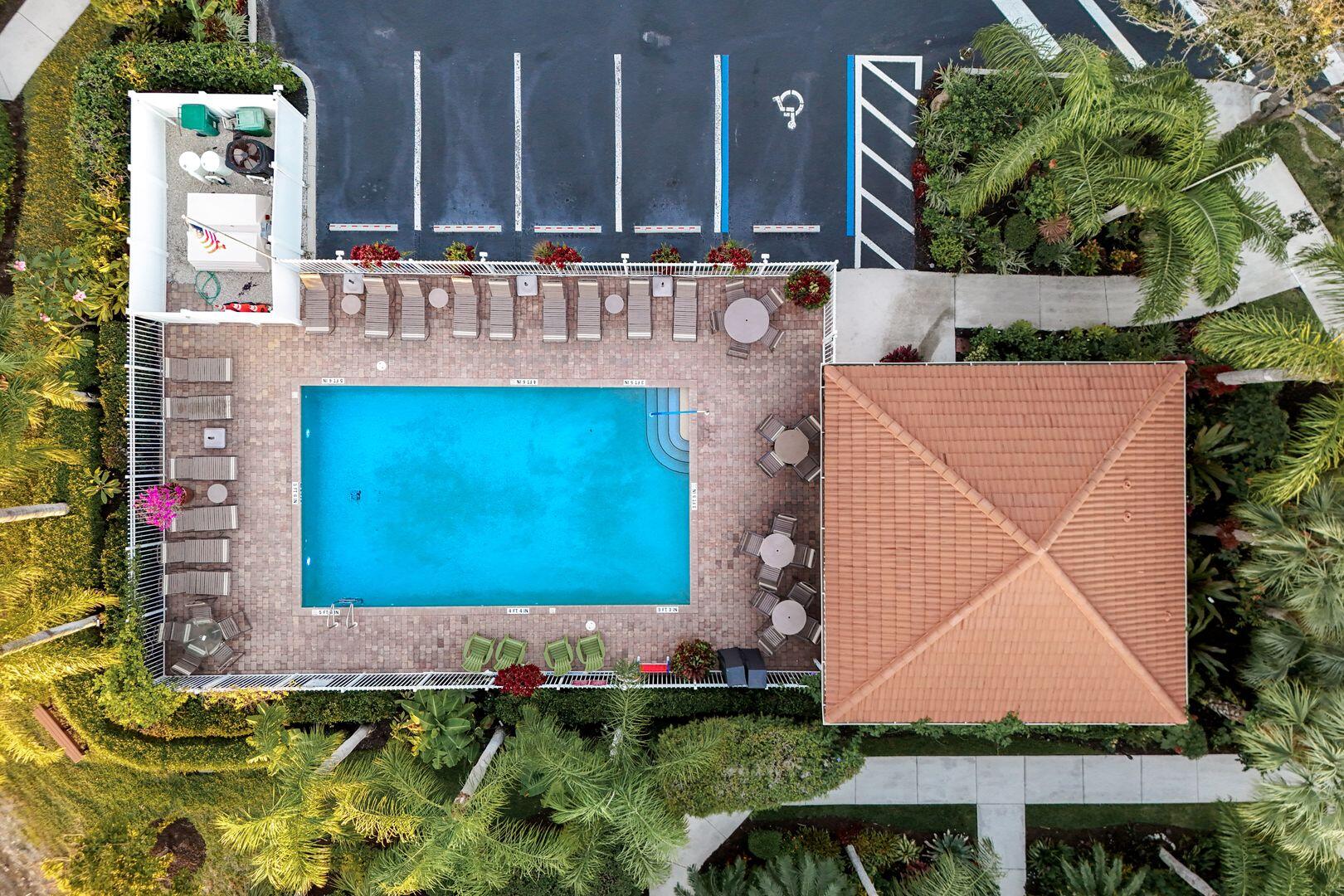 7878 Clemson Street, Unit 102 Naples, FL 34104 - Photo 18 of 20 a view of swimming pool with a yard