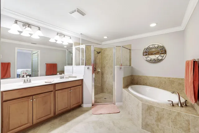a bathroom with a tub a sink and mirror