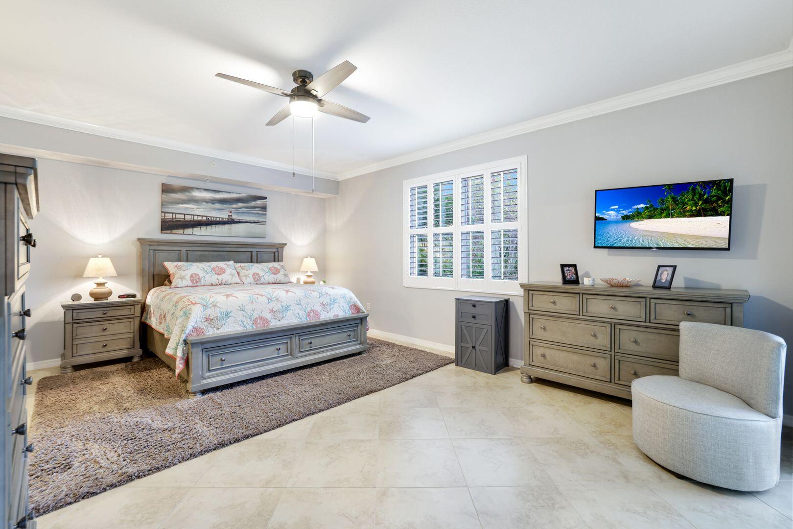 7878 Clemson Street, Unit 102 Naples, FL 34104 - Photo 10 of 20 a bedroom with a bed and a couch