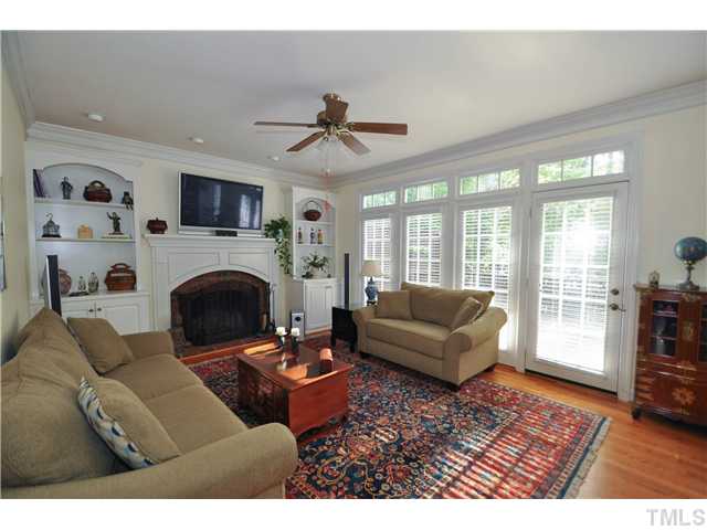 1805 Liatris Lane Raleigh, NC 27613 - Photo 6 of 25 Cozy yet spacious family room with a gorgeous masonry fireplace and a built-in shelving and cabinets. Access to the wonderful back deck.