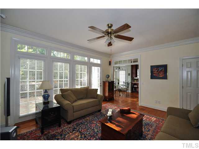 1805 Liatris Lane Raleigh, NC 27613 - Photo 7 of 25 Cozy yet spacious family room with a gorgeous masonry fireplace and a built-in shelving and cabinets. Access to the wonderful back deck.