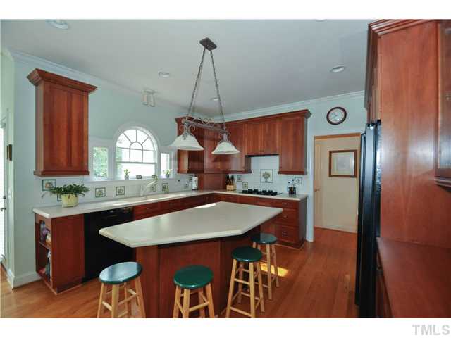 1805 Liatris Lane Raleigh, NC 27613 - Photo 8 of 25 Cook friendly kitchen with a new microwave and dishwasher. Large center island is ideal for food prep with a eat-in bar area as well. Perfect spot to entertain while cooking!
