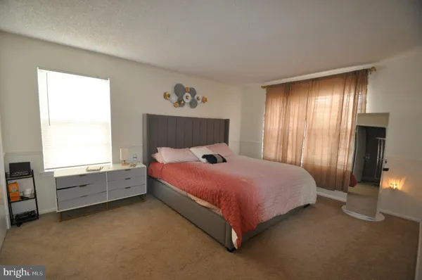 a spacious bedroom with a bed and a window