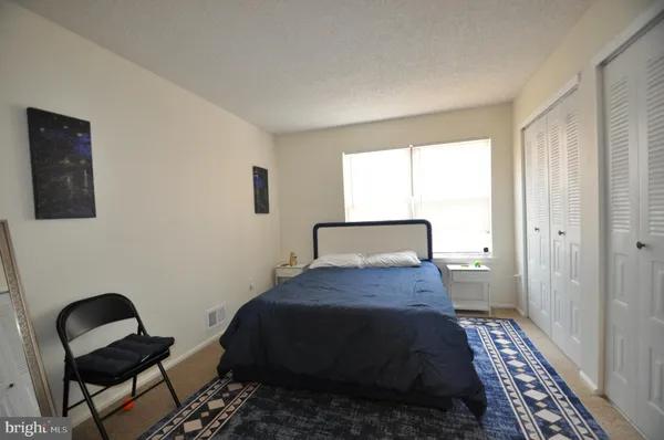 a bedroom with a bed and a chair