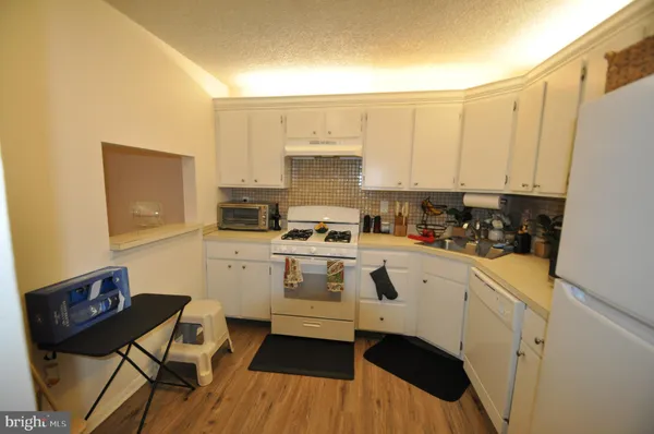 a kitchen with a stove a sink and a refrigerator