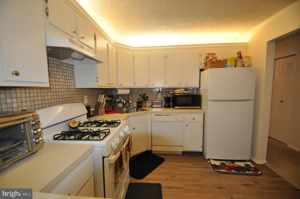 a kitchen with a refrigerator stove and sink
