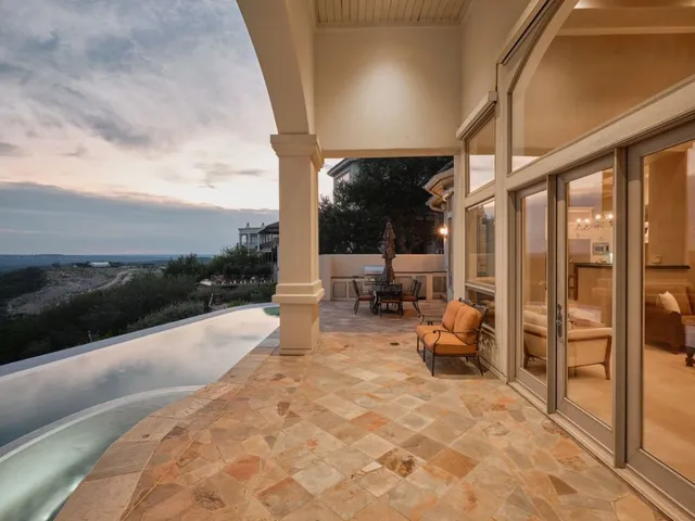 a view of a terrace with furniture and a yard
