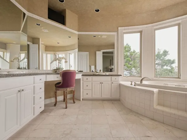 an aerial view of residential houses with outdoor space and trees