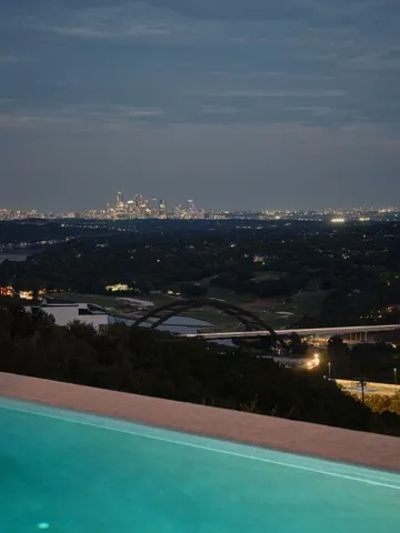 a view of a patio with a table and chairs and potted plants