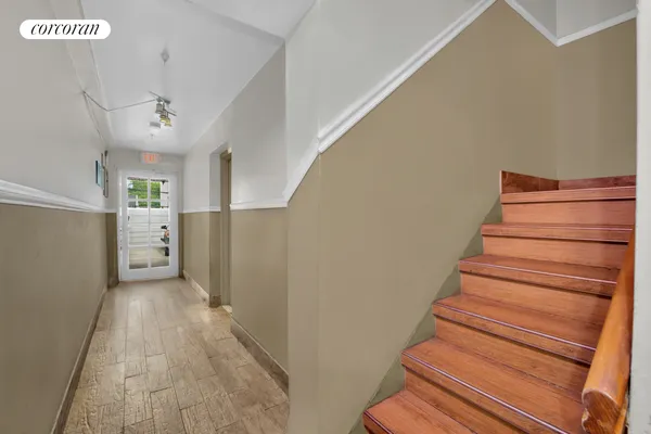 a view of entryway and hall with wooden floor