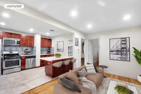 a large white kitchen with stainless steel appliances granite countertop a stove and a refrigerator