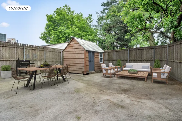 a view of backyard with a table and chairs