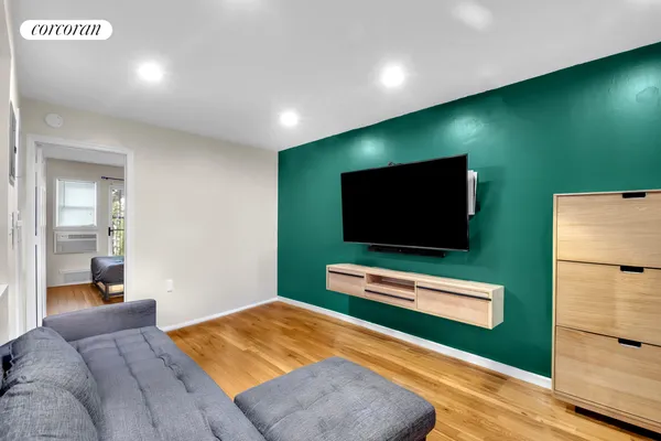 a living room with furniture and a flat screen tv