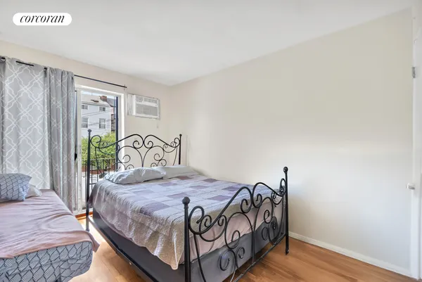 a bedroom with a bed table and a window