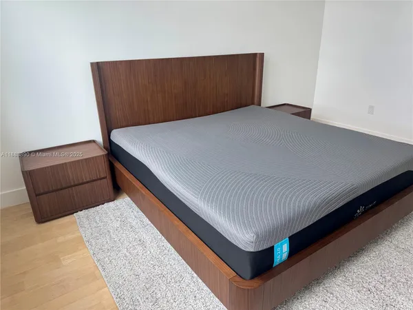 a bedroom with a bed and mirror