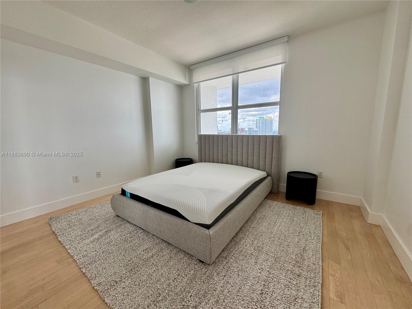 31 Southeast 5th Street, Unit 3817 Miami, FL 33131 - Photo 13 of 26 a bedroom with a bed and a window