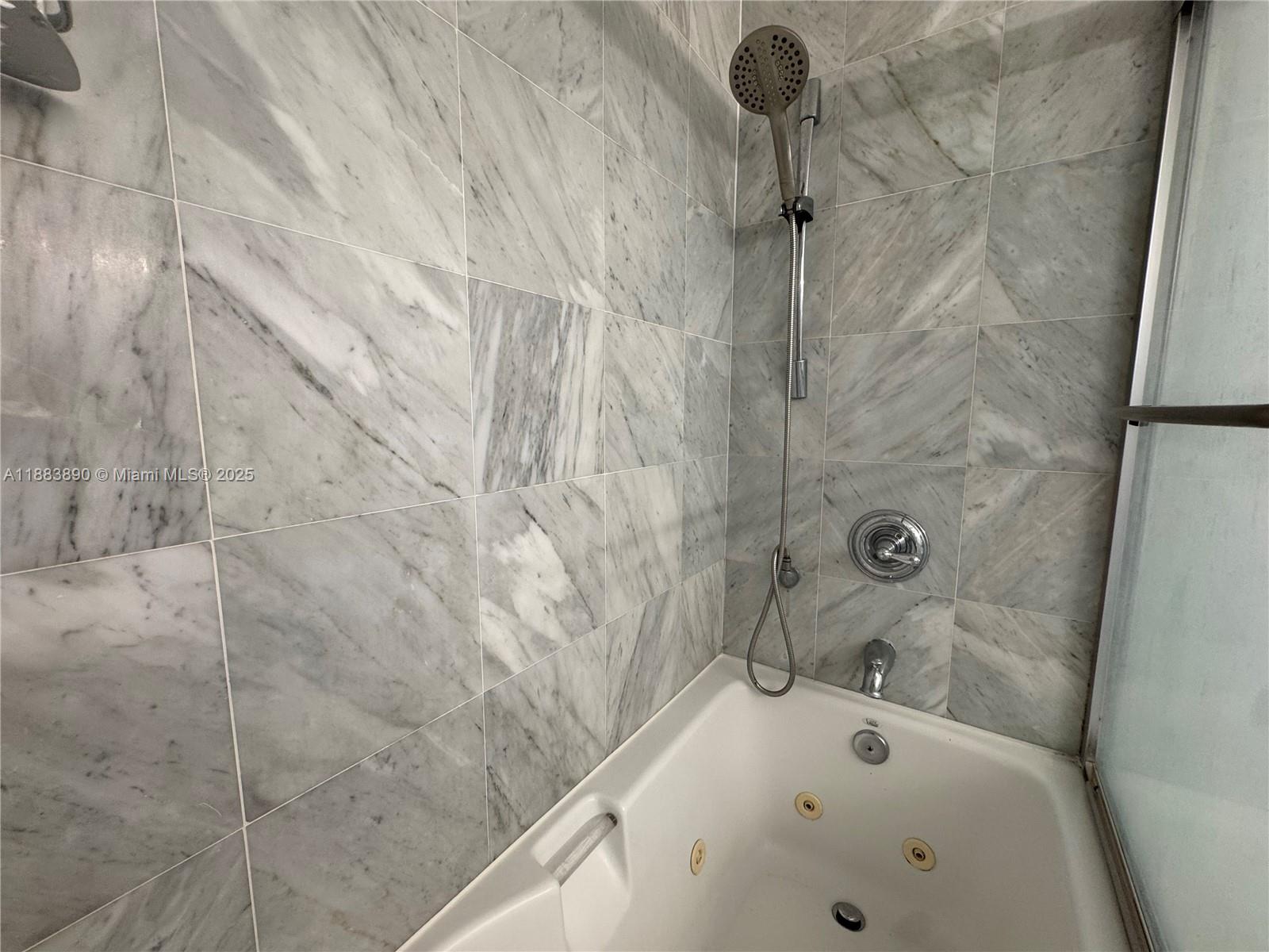 31 Southeast 5th Street, Unit 3817 Miami, FL 33131 - Photo 21 of 26 a bathroom with a bathtub and shower