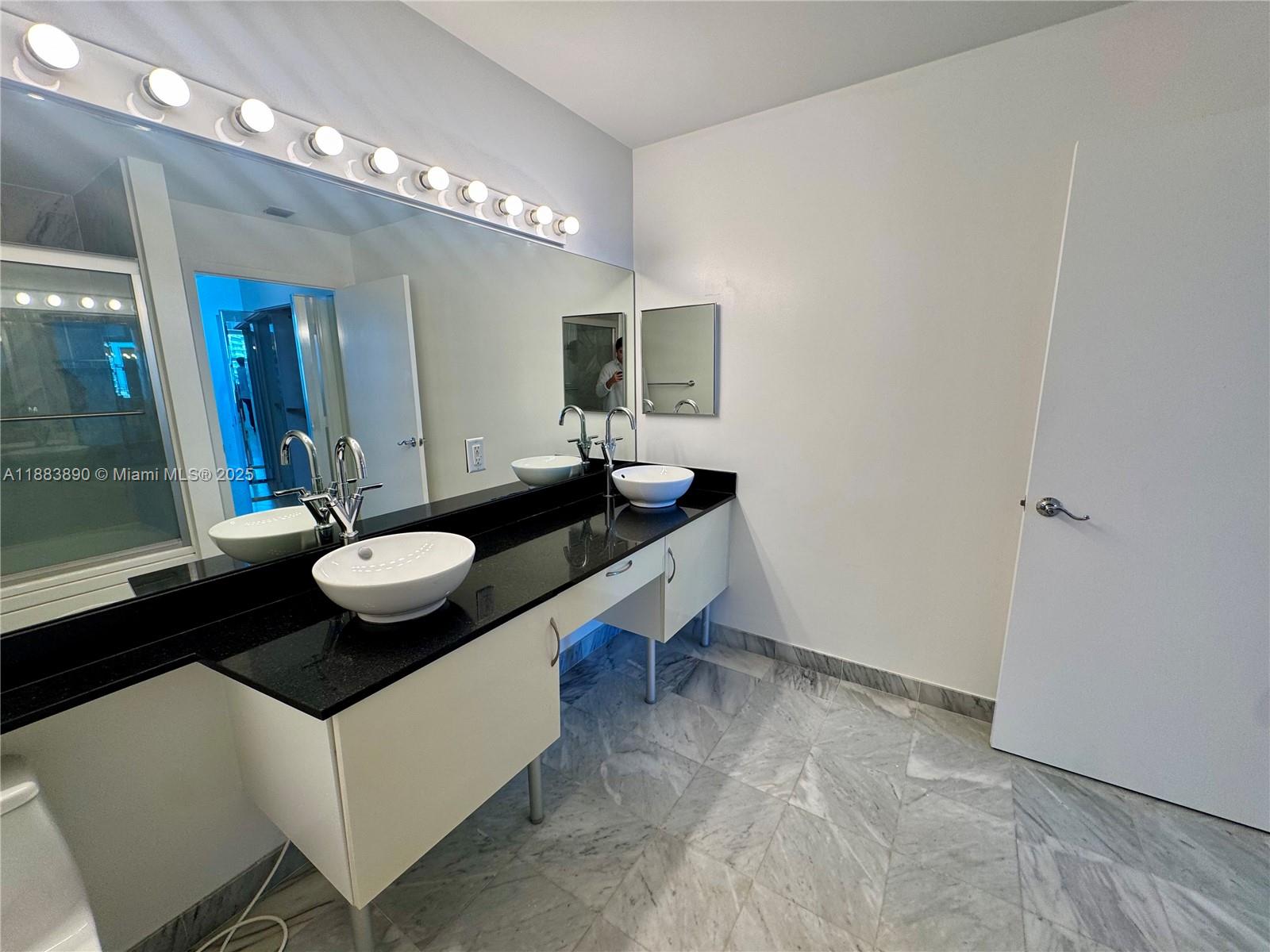 31 Southeast 5th Street, Unit 3817 Miami, FL 33131 - Photo 23 of 26 a room with sink and mirror