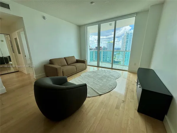 a living room with furniture and a large window