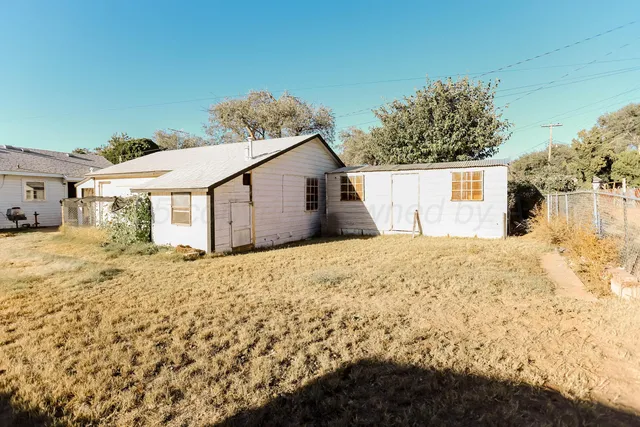 a view of a house with a snow on the road and yard