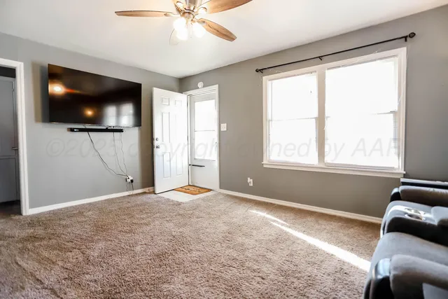 a view of livingroom with workspace and window