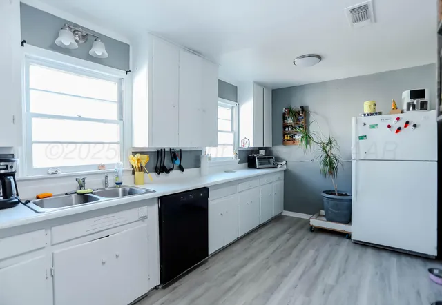 a kitchen with a refrigerator and window