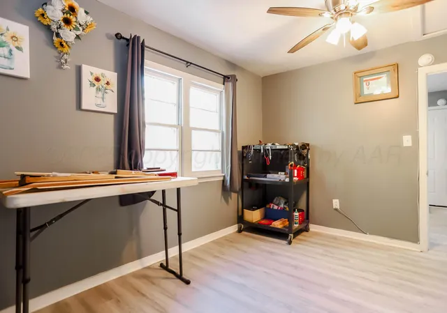 a room with a window and wooden floor