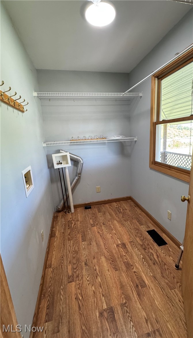6255 Highland Ridge Road Lowell, OH 45744 - Photo 11 of 40 Washroom with hookup for a washing machine, wood finished floors, and baseboards