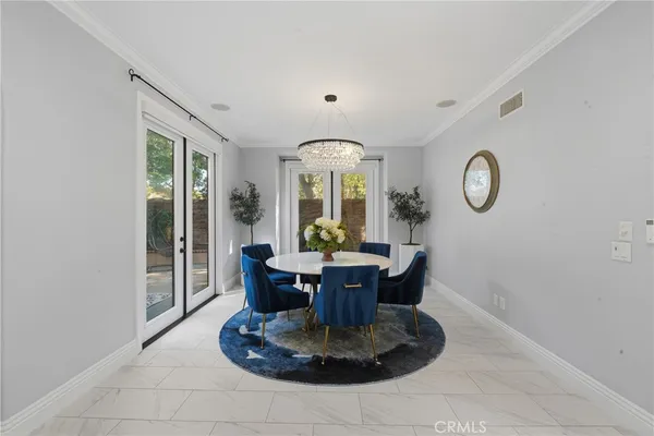 a living room with furniture kitchen and a table