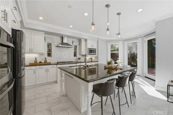 a kitchen with granite countertop white cabinets and white appliances